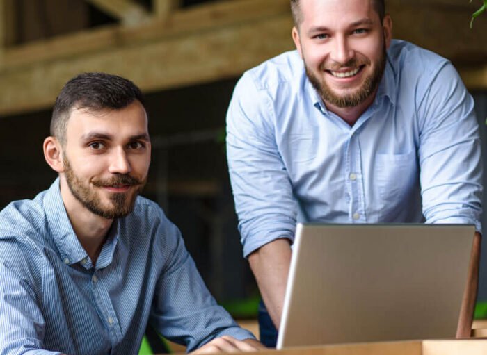 picture-handsome-businessman-listening-his-colleague-partner-concerning-ner-business-system-while-working-laptop-computer-office-interior picture-handsome-businessman-listening-his-colleague-partner-concerning-ner-business-system-while-working-laptop-computer-office-interior
